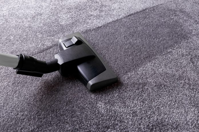 Grey carpet texture and cleaner, close up, indoors interior design